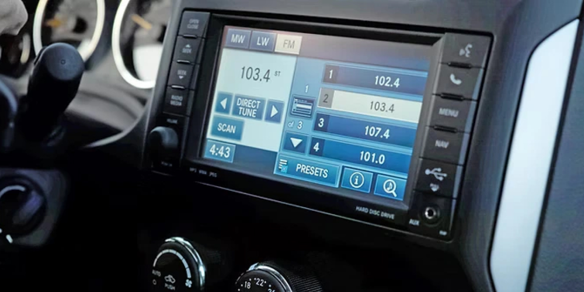 Close-up of a car infotainment system displaying FM radio settings, tuned to station 103.4 with other preset options including 102.4, 107.4, and 101.0, and the time shown as 4:43.