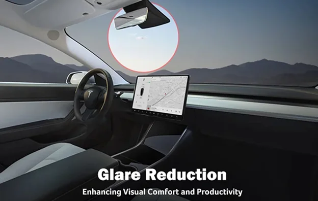 Interior of a Tesla vehicle with the sun visibly causing glare through the windshield, emphasizing the benefits of window tinting for glare reduction. On-screen text reads “Glare Reduction – Enhancing Visual Comfort and Productivity.”