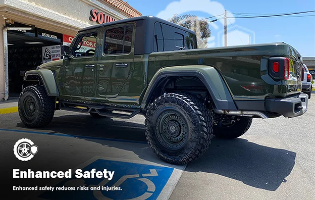 Lifted olive green Jeep Gladiator parked outside a customization shop, equipped with off-road tires, side steps, and aftermarket suspension. Text overlay reads “Enhanced Safety – Enhanced safety reduces risks and injuries,” with a safety gear icon.