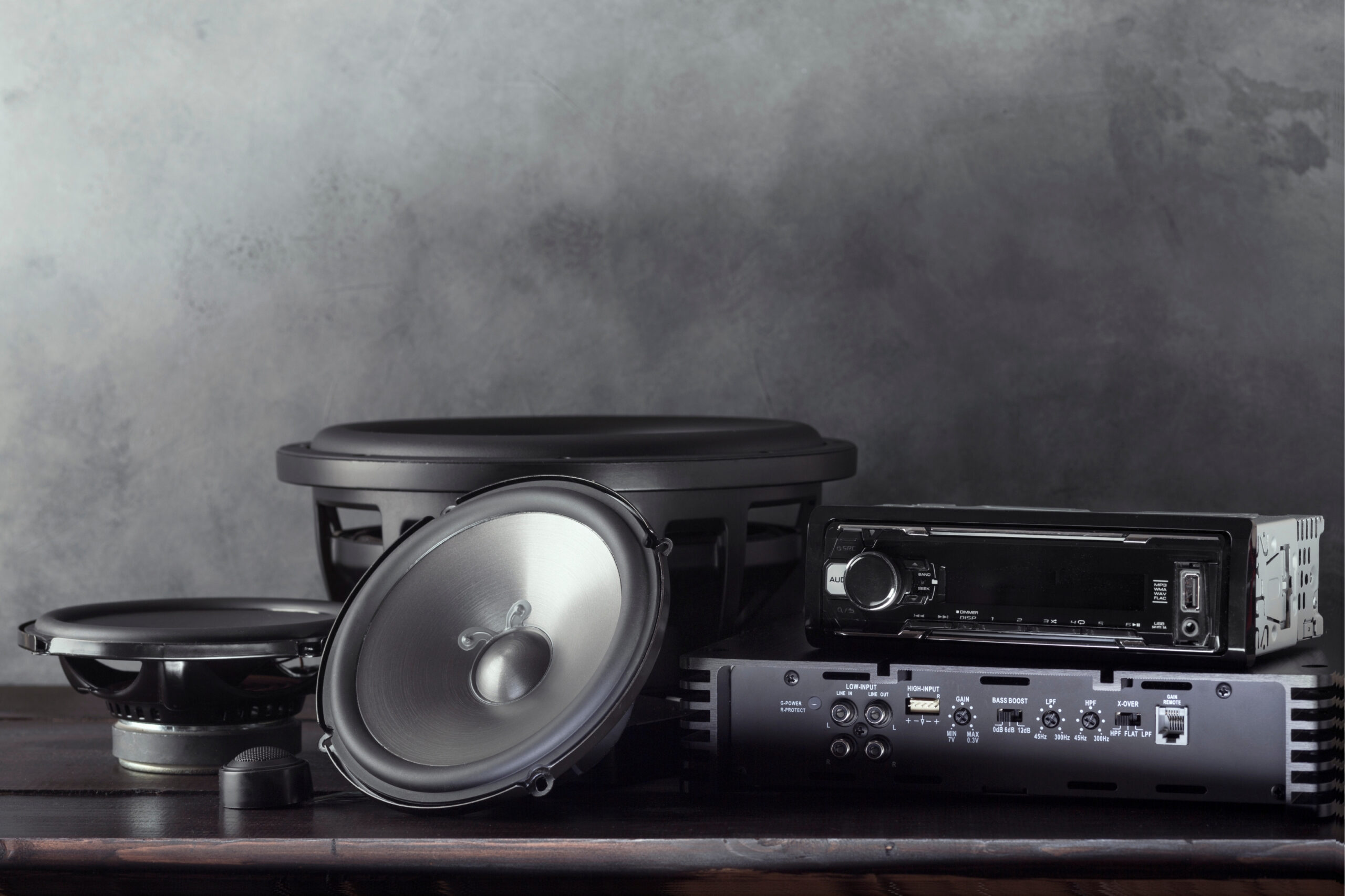 High-quality car audio upgrade kit featuring sleek speakers, a deep-bass subwoofer, an advanced head unit, and a premium amplifier for a powerful in-car sound experience.