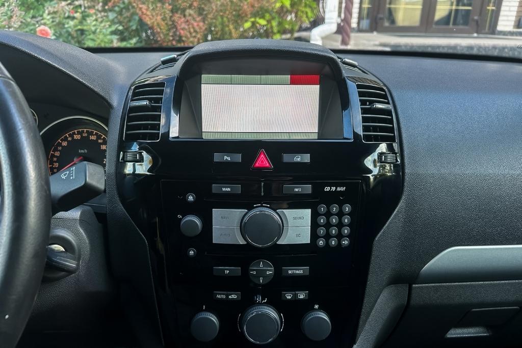 Factory car stereo system with outdated navigation and limited audio controls, ready for a modern upgrade.