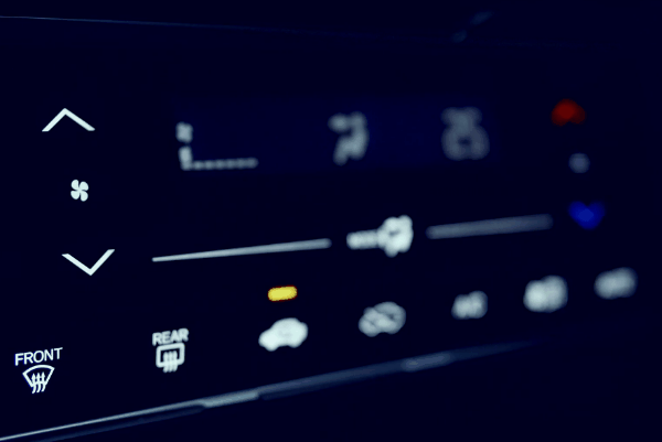 Driver adjusting touchscreen car stereo settings on a modern vehicle infotainment system