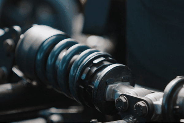 Close-up of a vehicle coilover suspension system for improved handling and ride comfort.